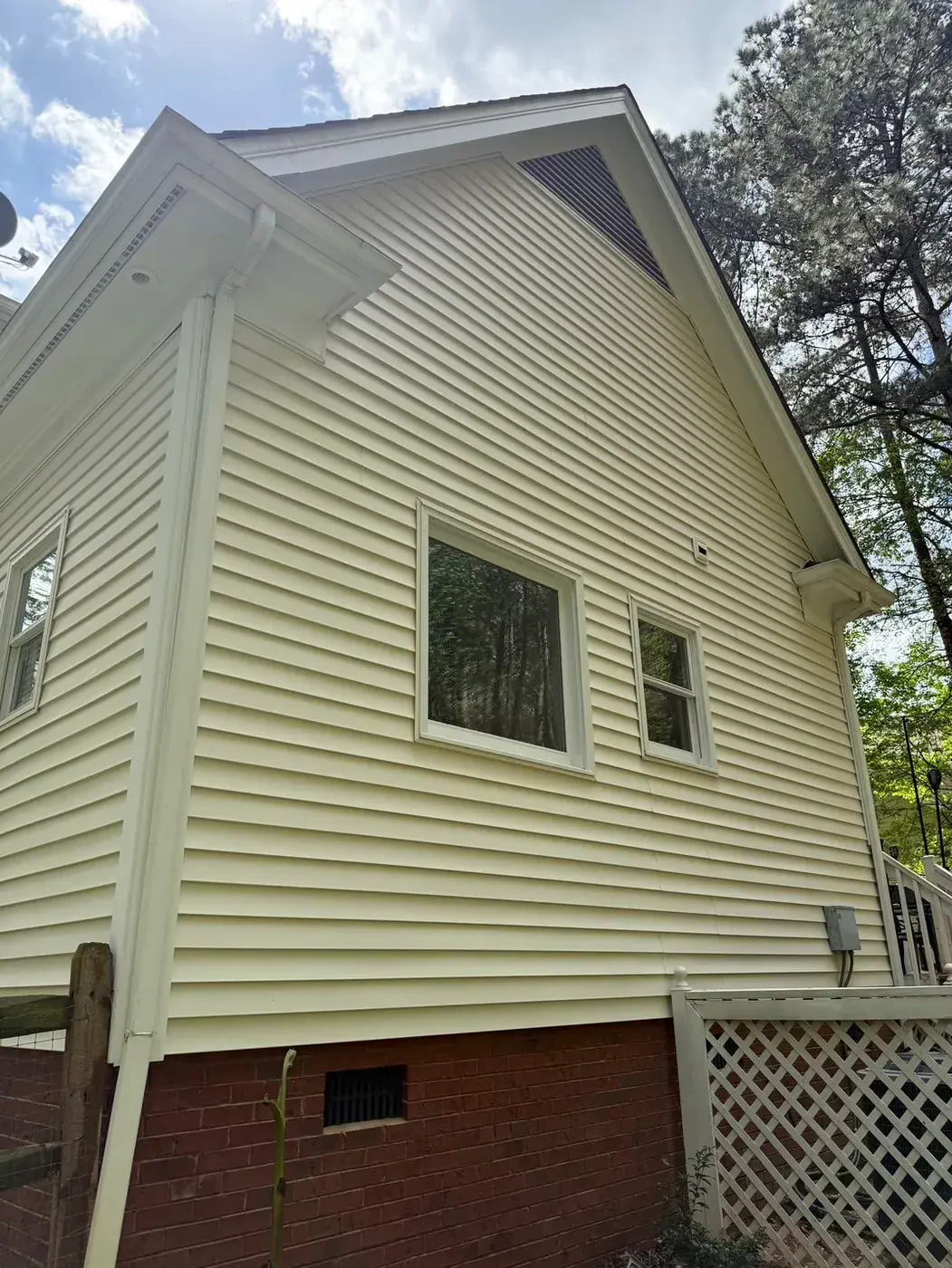 Clean white brick home exterior after pressure washing Denver NC