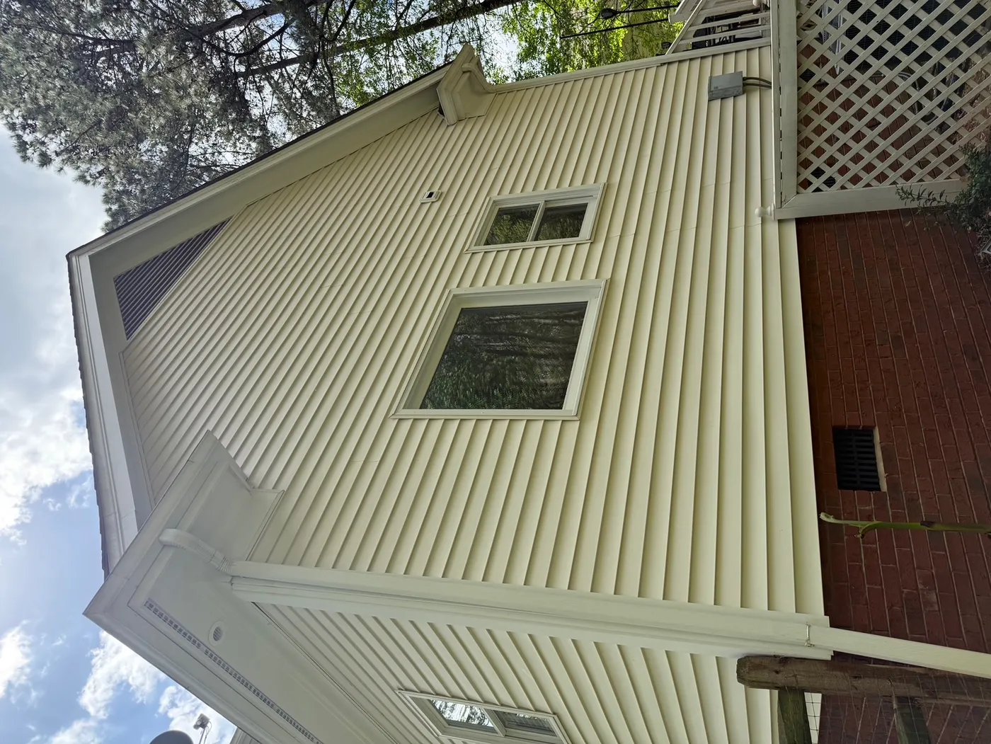 Clean white brick home exterior after pressure washing Denver NC