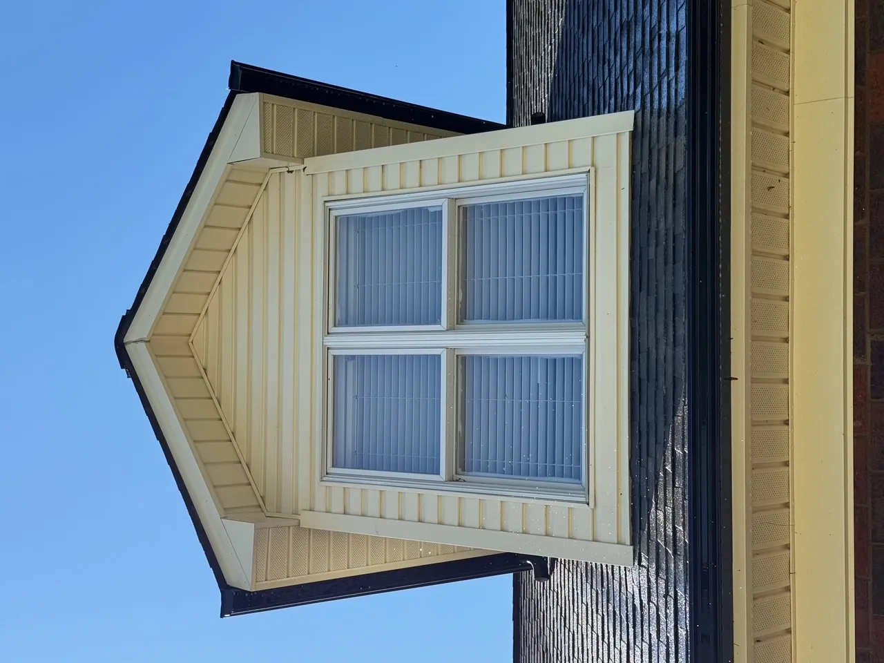 Clean dormer and roof siding after soft wash pressure washing