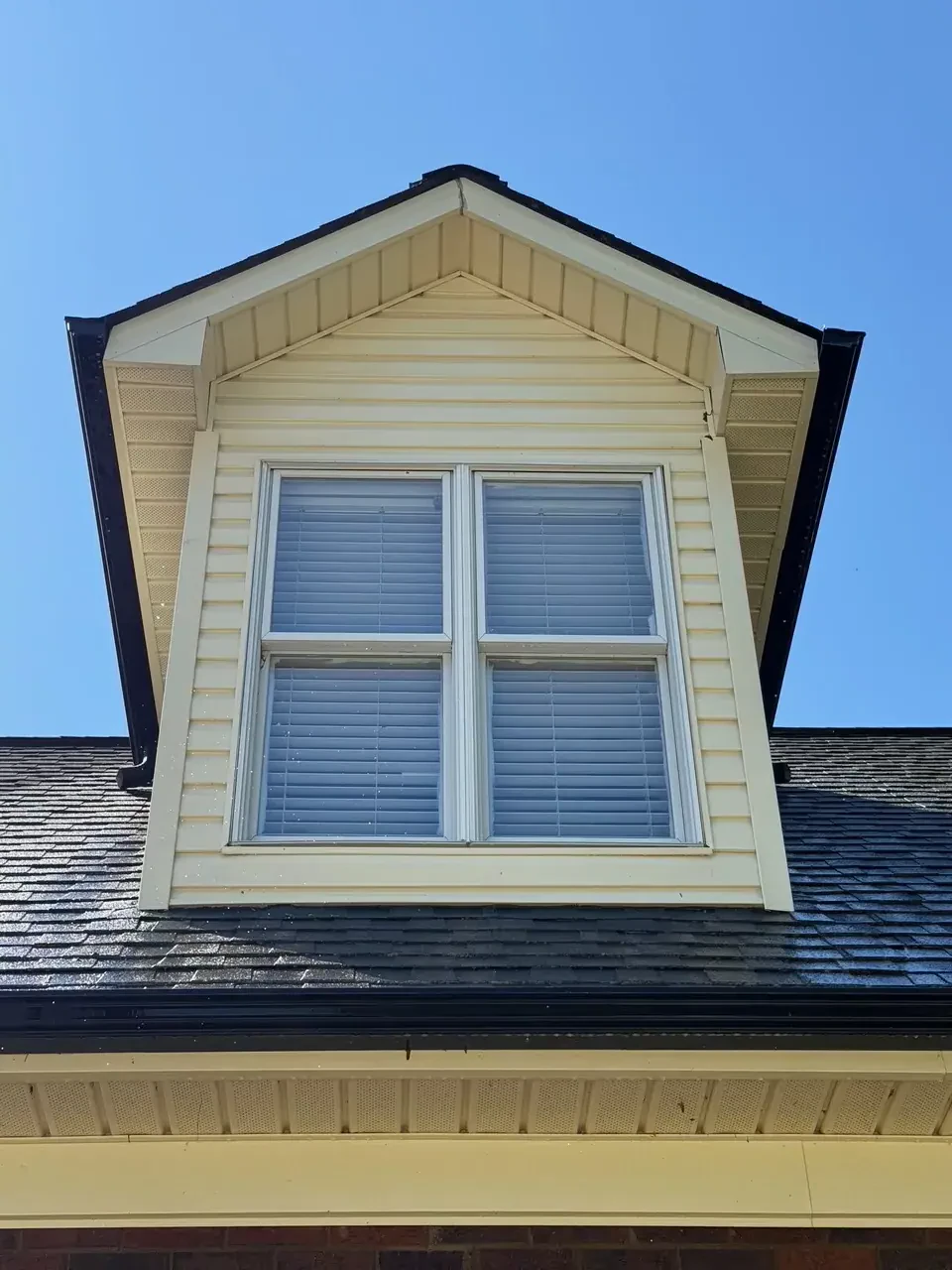 Clean dormer and roof siding after soft wash pressure washing